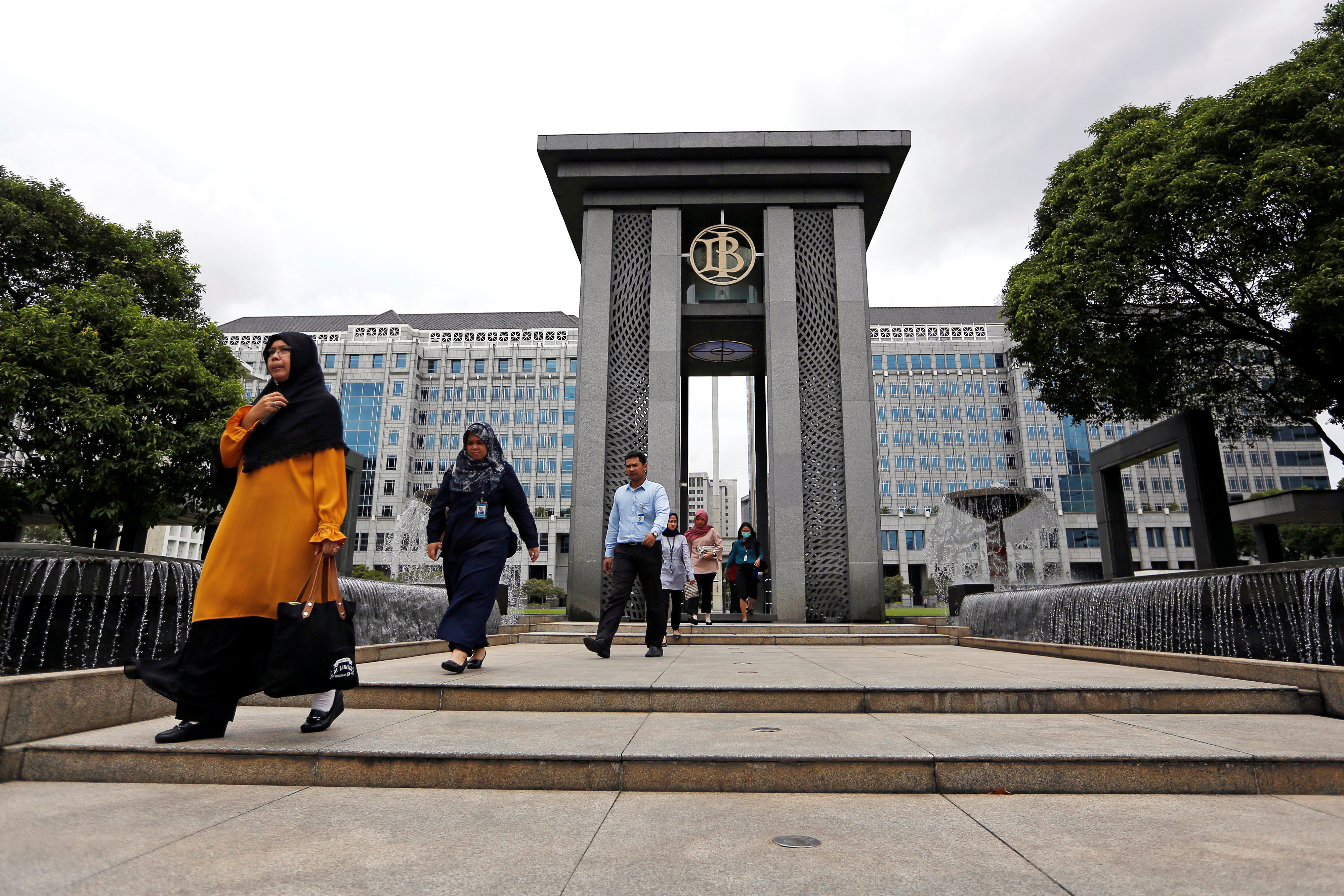 Visitors walk as they leave Bank Indonesia headquarters in Jakarta