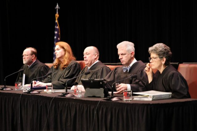 Members of the South Dakota Supreme Court hear oral arguments on March 19, 2024, in Aberdeen on a carbon pipeline case. From left are Justices Scott Myren, Janine Kern, Steven Jensen and Mark Salter. Judge Jane Wipf Pfeifle, at right, sat in for Justice Patricia DeVaney, who disqualified herself from the case. (Dave Bordewyk/South Dakota NewsMedia Association)