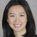 Jane Zhu, M.D. (Courtesy) has long dark hair and is smiling against a gray background.