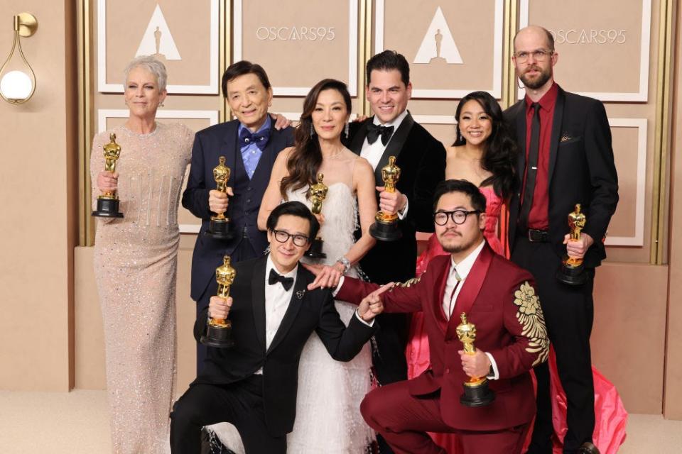 The cast of "Everything Everywhere All At Once" holds their Oscars for best picture.